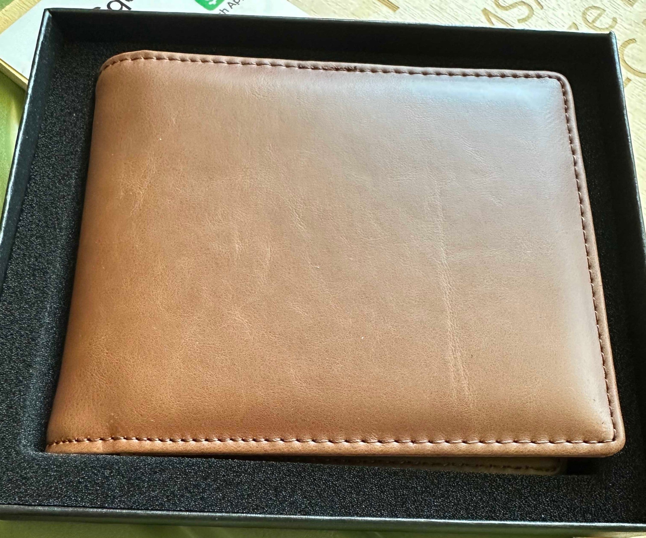 Papa Tee's classic bifold wallet for men in warm brown full-grain leather with meticulous stitching.