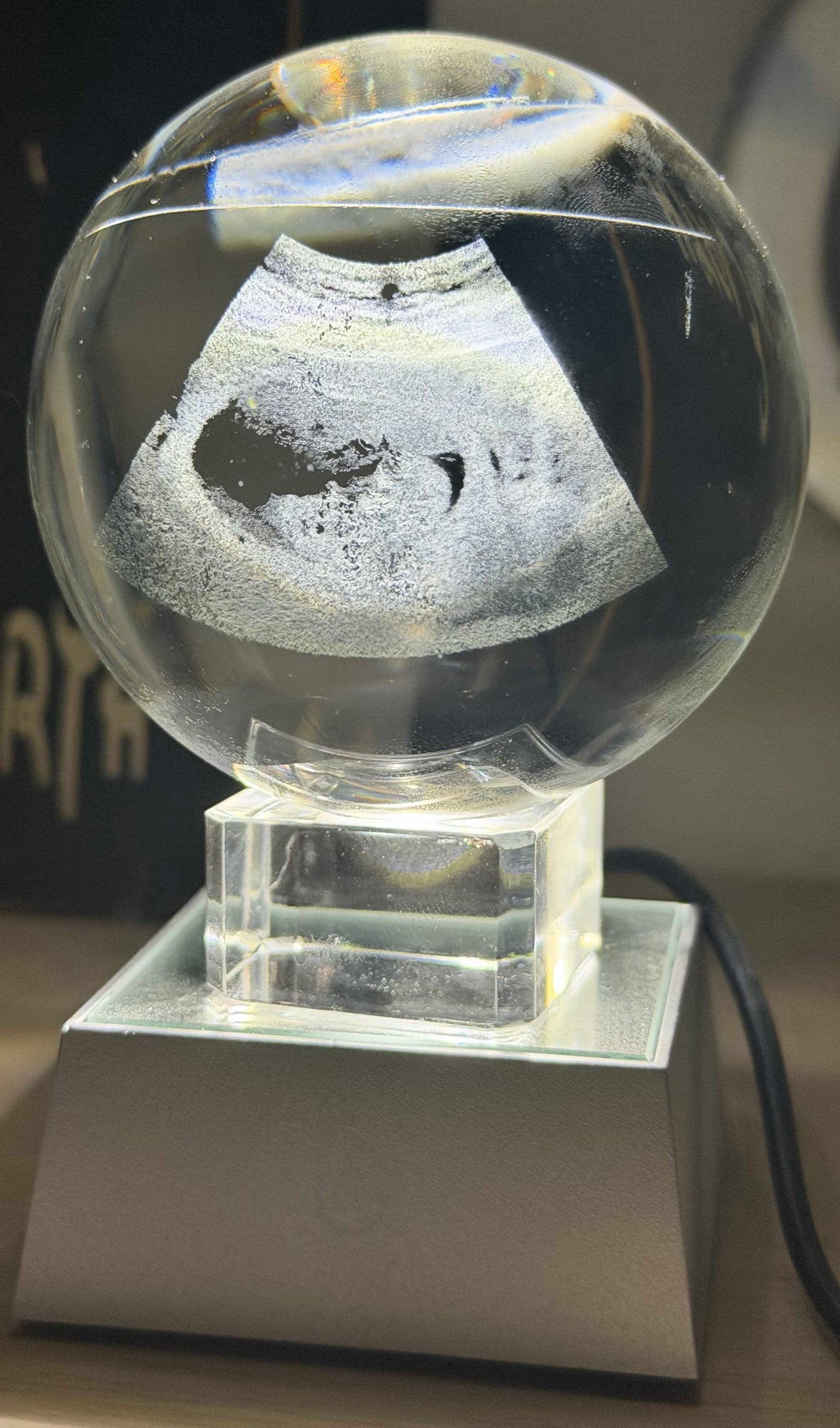 Papa Tee's personalized crystal keepsake with etched ultrasound image, illuminated by LED base.