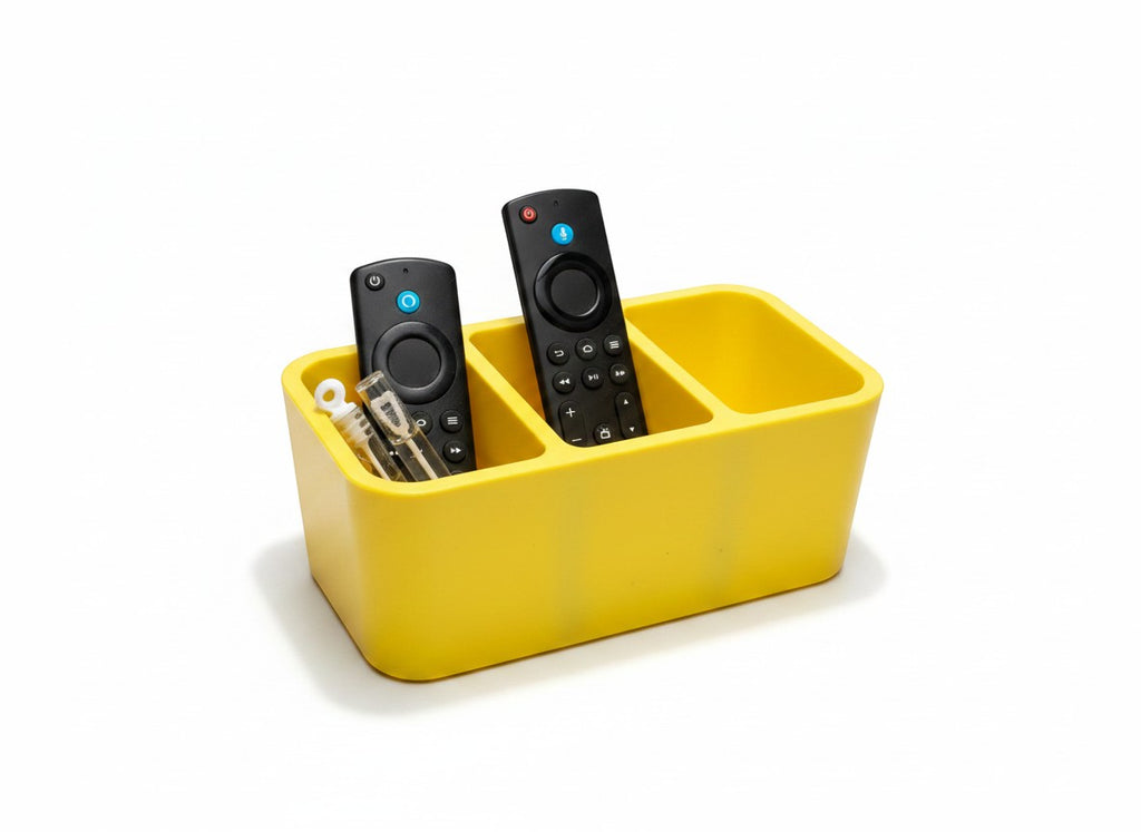 Papa Tee's vibrant yellow plastic remote control organizer with three compartments holding two remotes and small accessories.