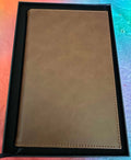 Papa Tee's classic tan faux leather journal notebook with stitched detailing, perfect for notes and planning.