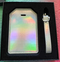 Papa Tee's iridescent holographic luggage tag set with strap, shifts through pastel colors, perfect for travel.